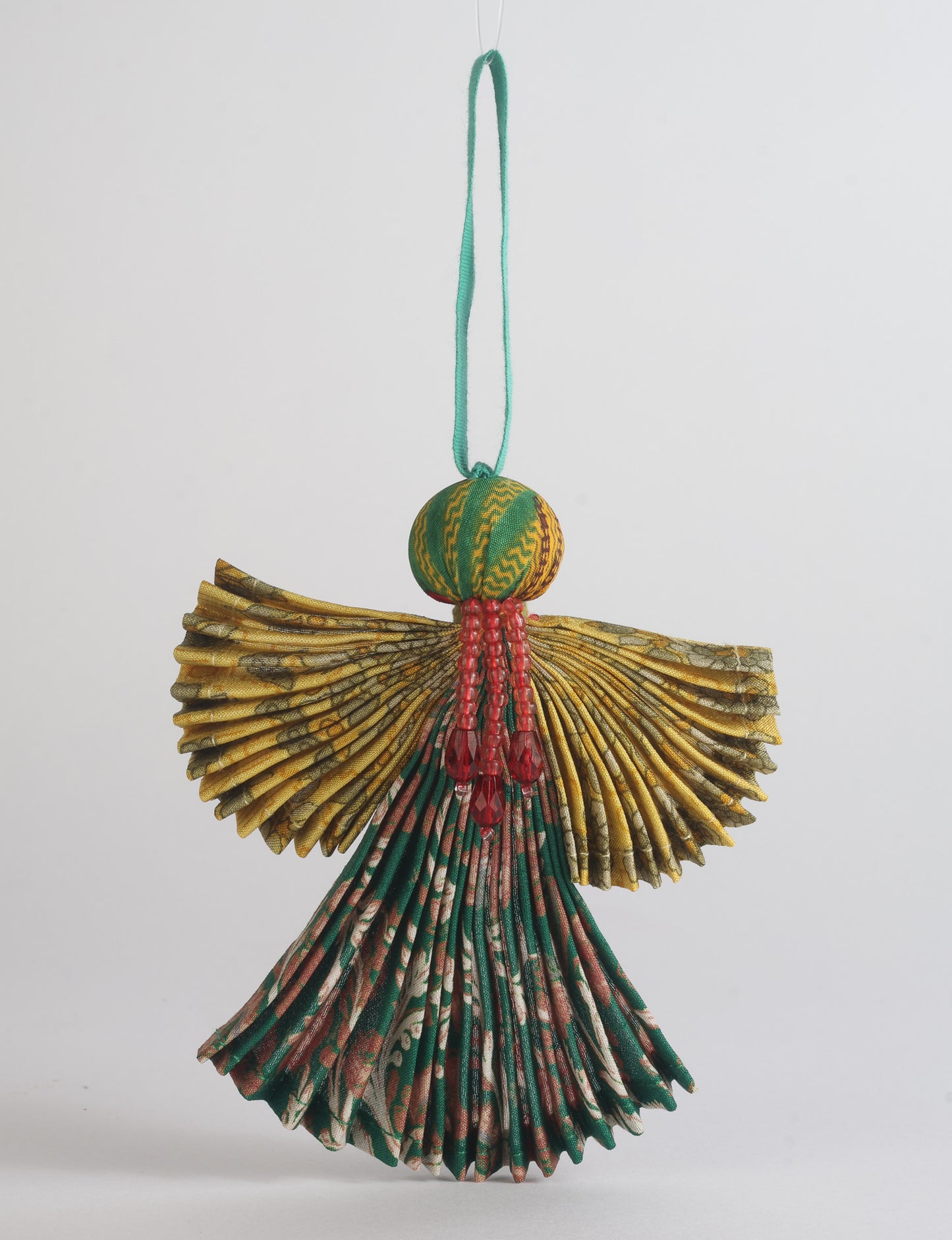 Angel Christmas Ornament made from upcycled saris, featuring pleated arms and body. A sustainable, eco-friendly holiday decoration, embodying recycled fashion and upcycling in festive style.






