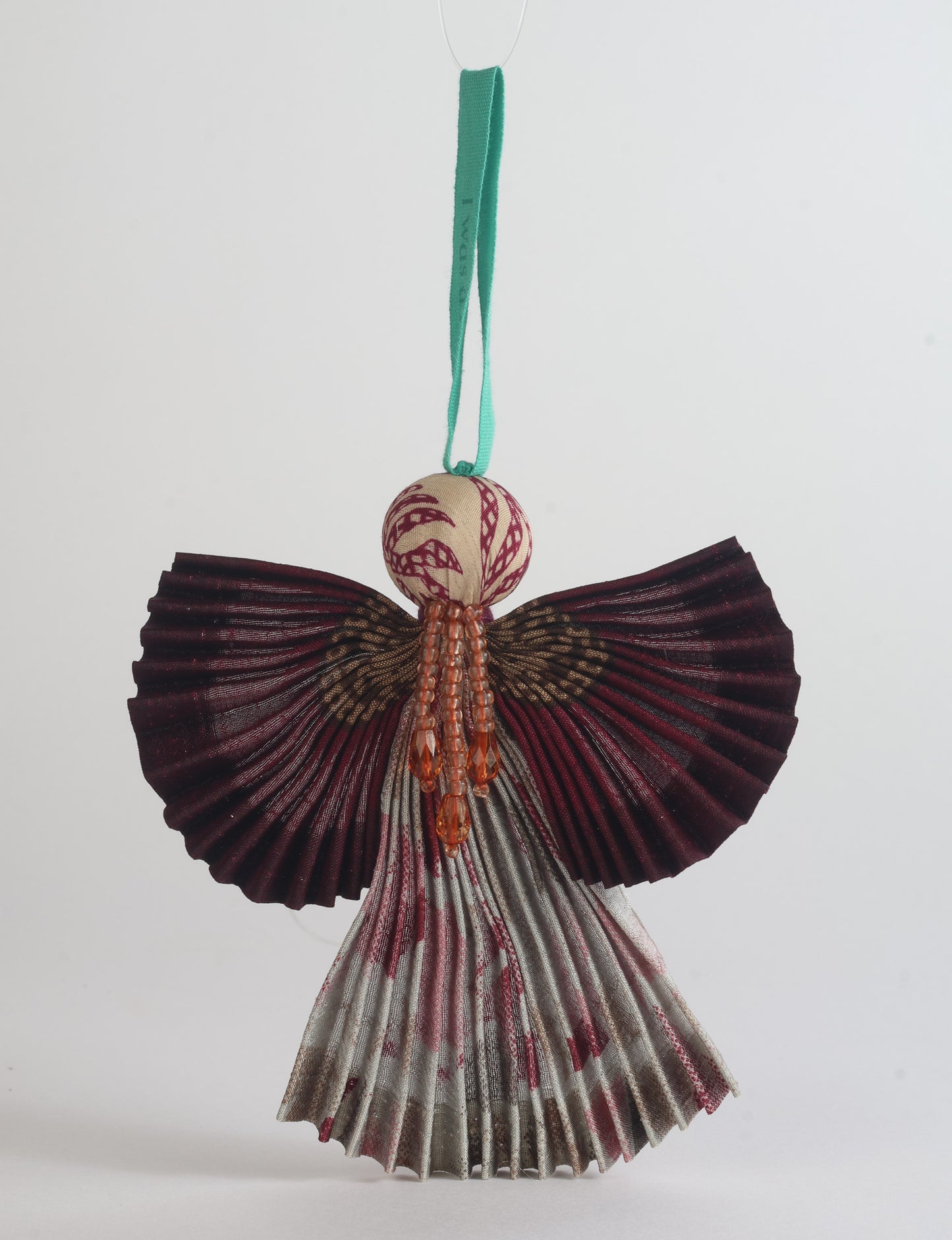 Angel Christmas Ornament made from upcycled saris, featuring pleated arms and body. A sustainable, eco-friendly holiday decoration, embodying recycled fashion and upcycling in festive style.





