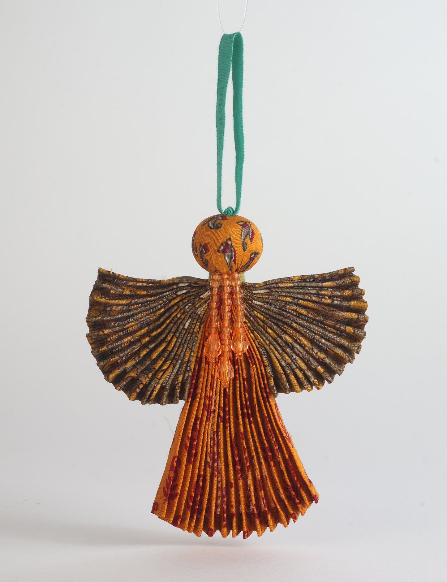 Angel Christmas Ornament made from upcycled saris, featuring pleated arms and body. A sustainable, eco-friendly holiday decoration, embodying recycled fashion and upcycling in festive style.





