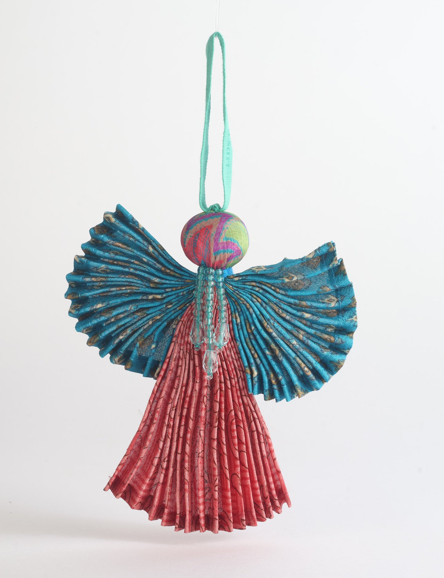 Angel Christmas Ornament made from upcycled saris, featuring pleated arms and body. A sustainable, eco-friendly holiday decoration, embodying recycled fashion and upcycling in festive style.





