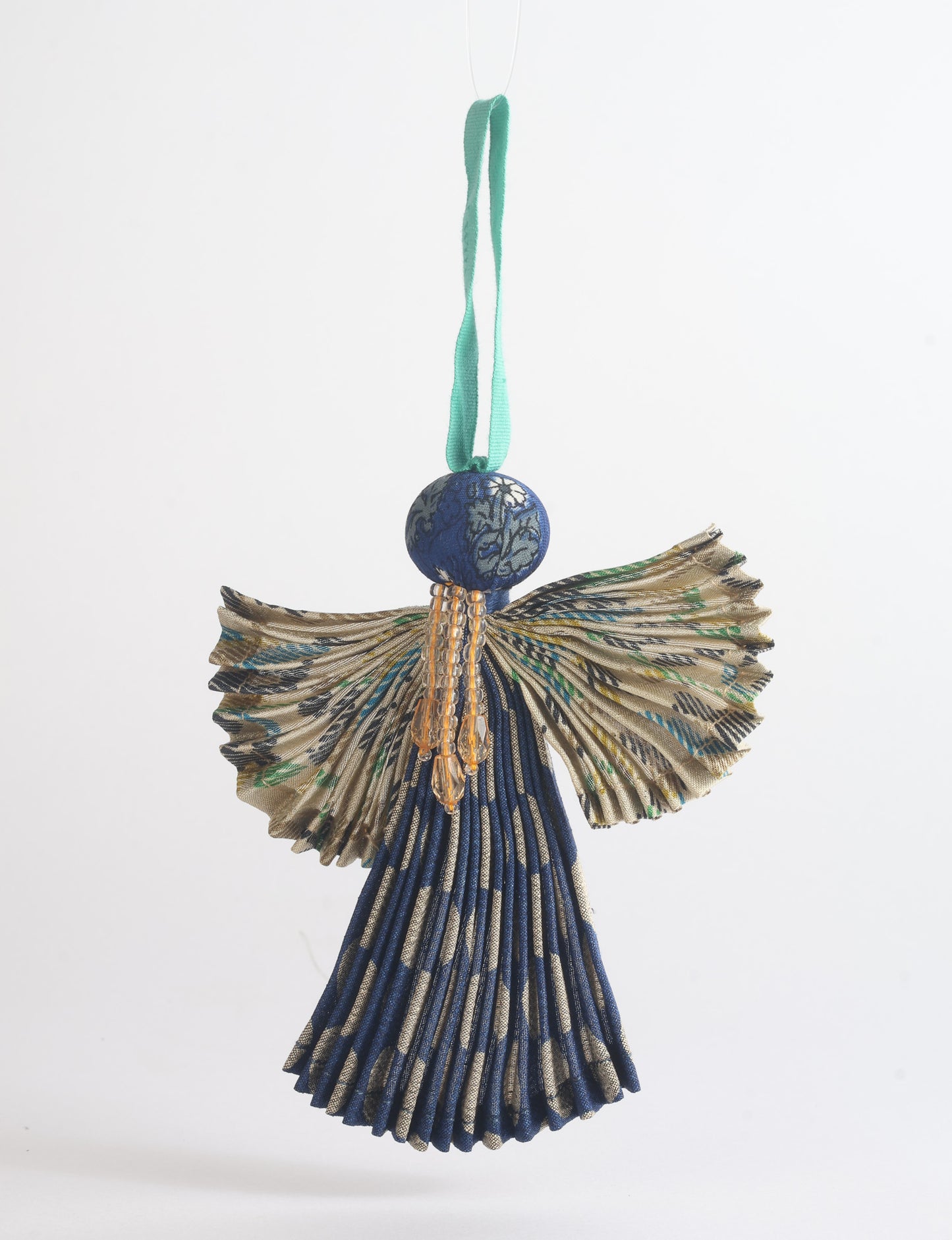 Angel Christmas Ornament made from upcycled saris, featuring pleated arms and body. A sustainable, eco-friendly holiday decoration, embodying recycled fashion and upcycling in festive style.





