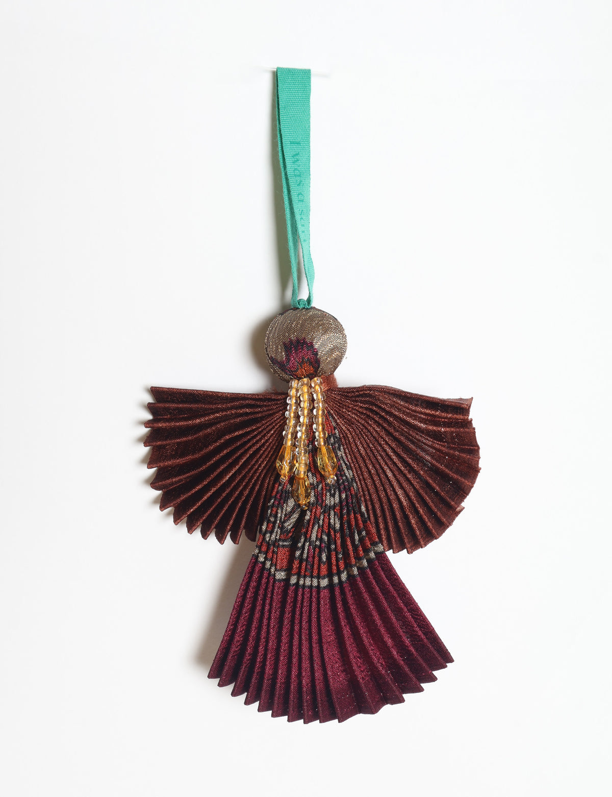 Angel Christmas Ornament made from upcycled saris, featuring pleated arms and body. A sustainable, eco-friendly holiday decoration, embodying recycled fashion and upcycling in festive style.





