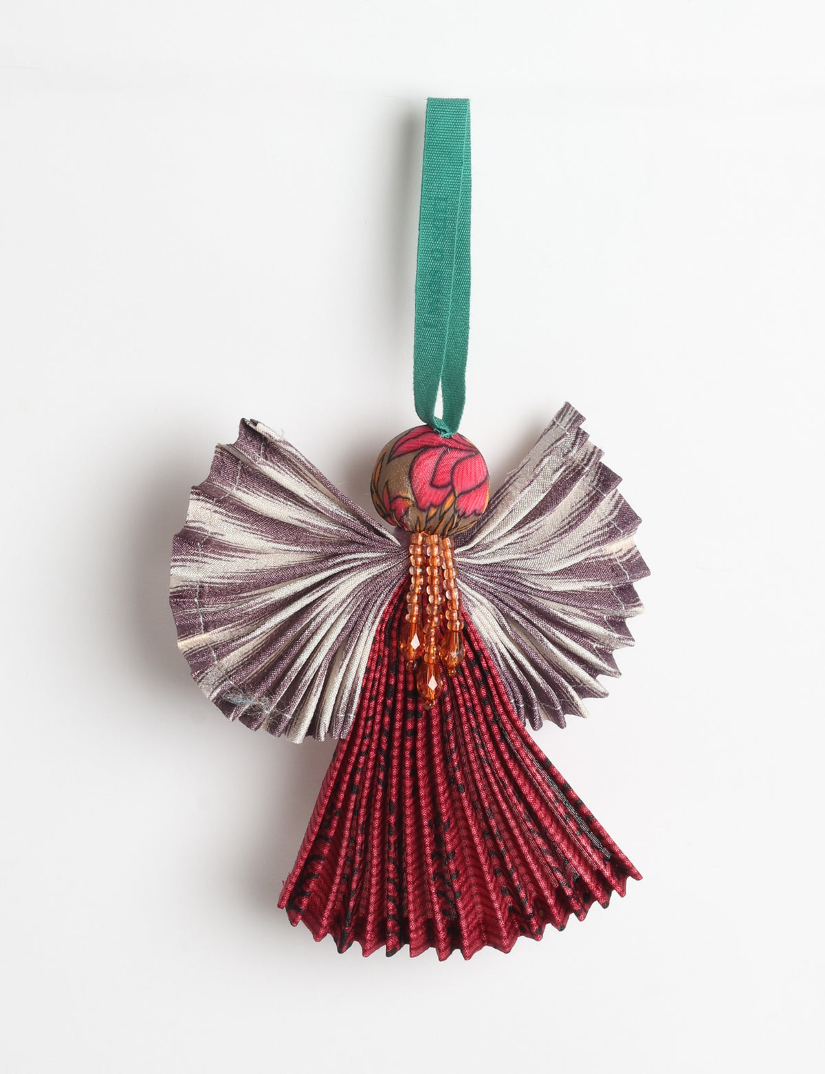 Angel Christmas Ornament made from upcycled saris, featuring pleated arms and body. A sustainable, eco-friendly holiday decoration, embodying recycled fashion and upcycling in festive style.





