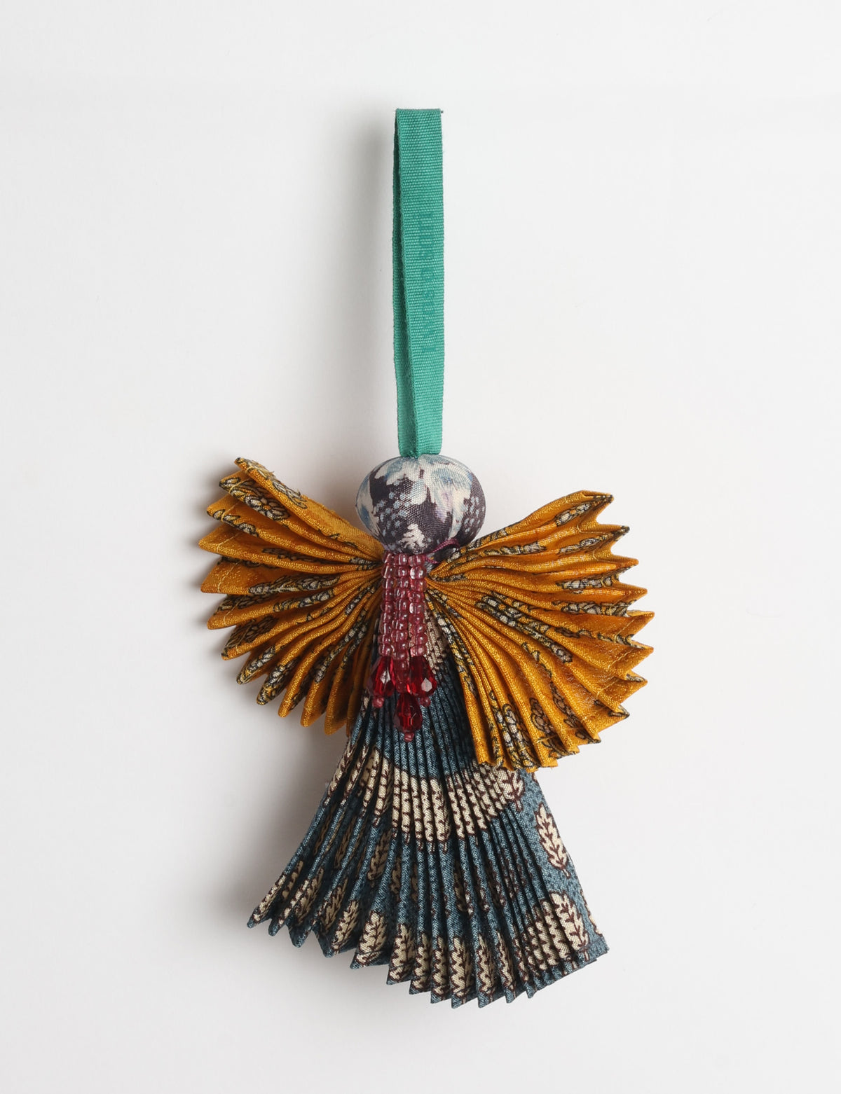 Angel Christmas Ornament made from upcycled saris, featuring pleated arms and body. A sustainable, eco-friendly holiday decoration, embodying recycled fashion and upcycling in festive style.





