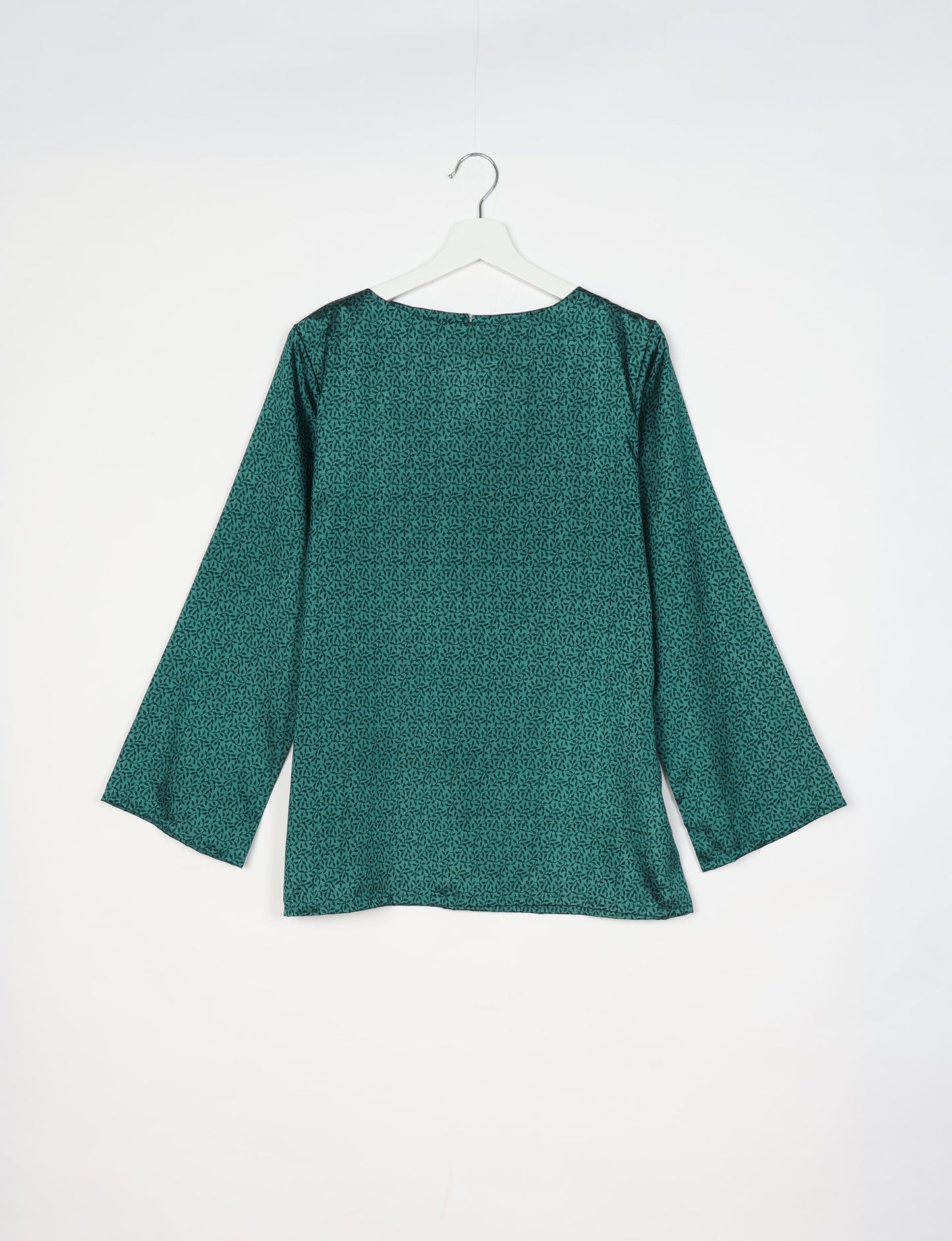 Green long-sleeve top with micro leaf pattern, round neckline, shown from back on white hanger against white background