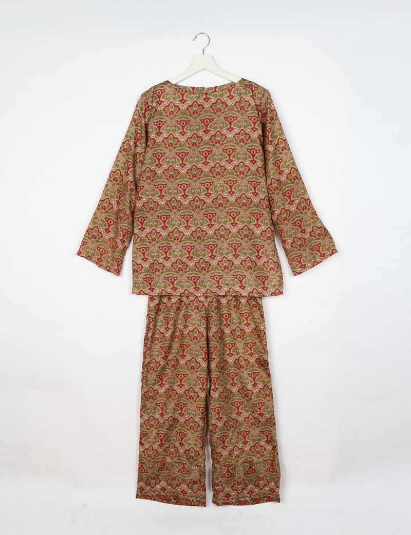Beige tropical patterned lounge set with long sleeves and wide-leg pants hanging on white hanger against white background
