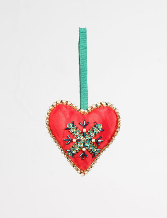 A Christmas heart ornament made from recycled sari fabric, featuring traditional Aari embroidery, representing sustainable, eco-friendly fashion. Handcrafted by artisans, this zero-waste, fair trade product symbolizes recycled material clothing and conscious clothing choices within eco-friendly and circular fashion.