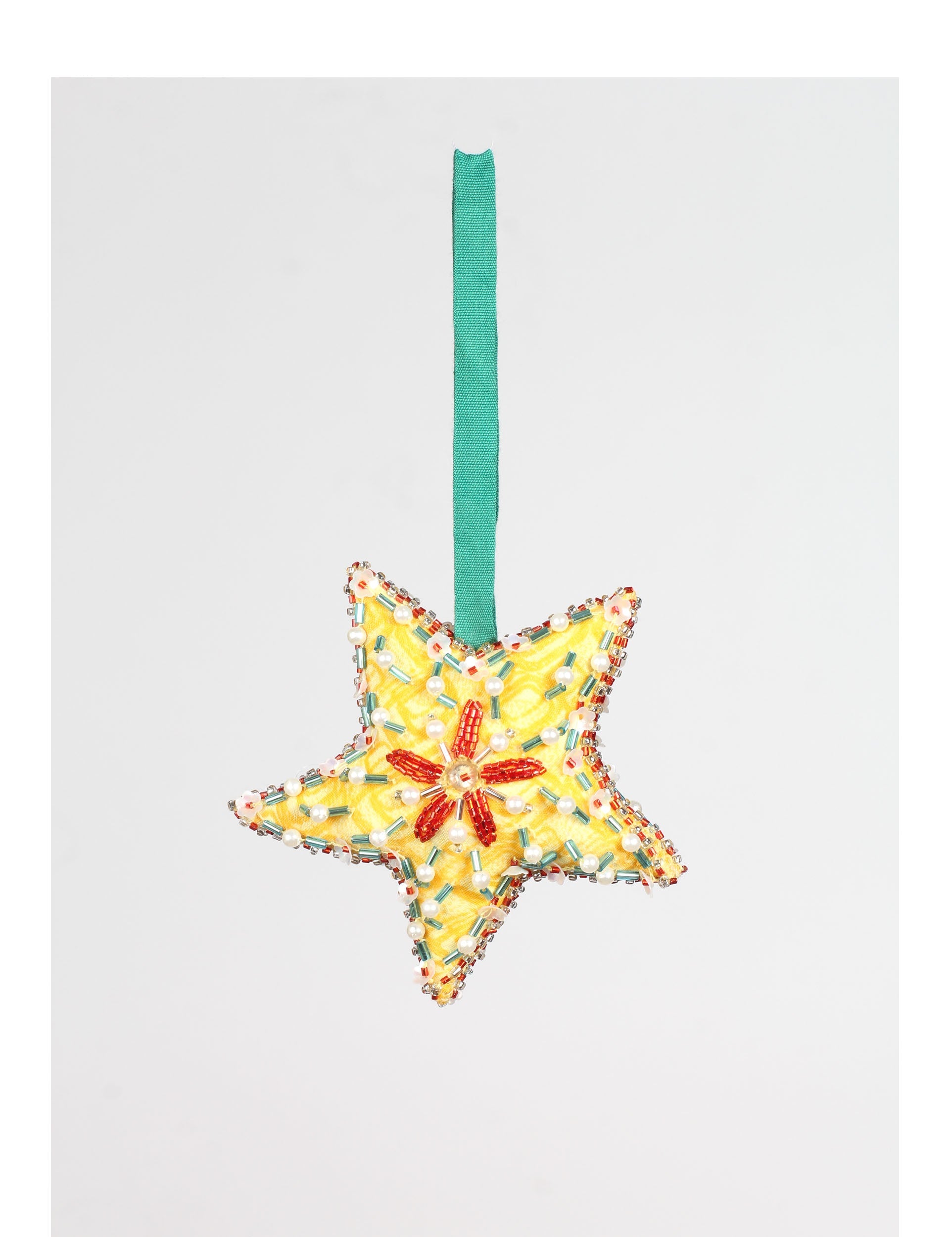 Yellow fabric star ornament with red, white, and green bead embellishments and a green hanging ribbon