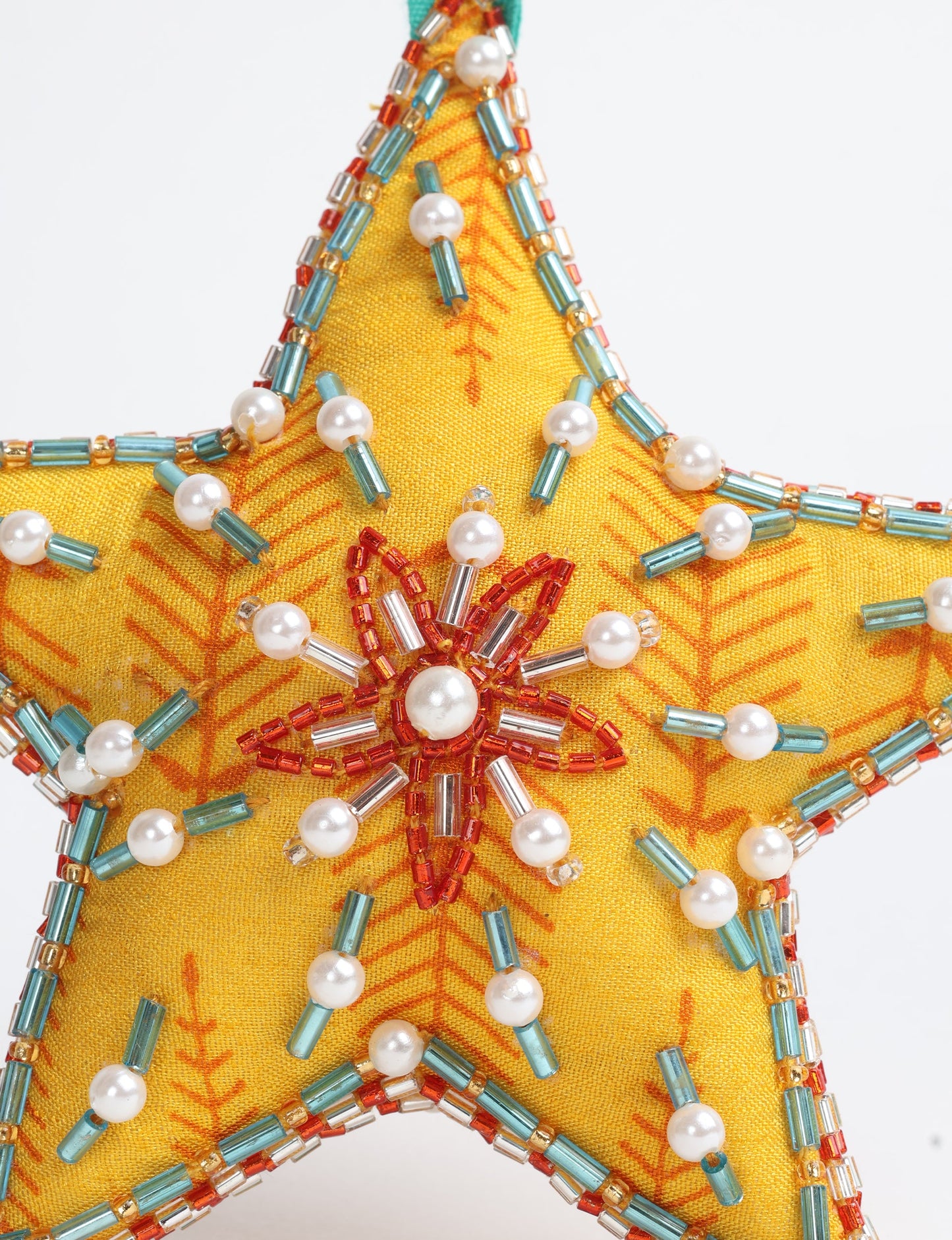 Christmas Star Ornaments made from upcycled saris with hand-embroidered Aari work, showcasing sustainable fashion and eco-friendly craftsmanship for ethical and green holiday decor.