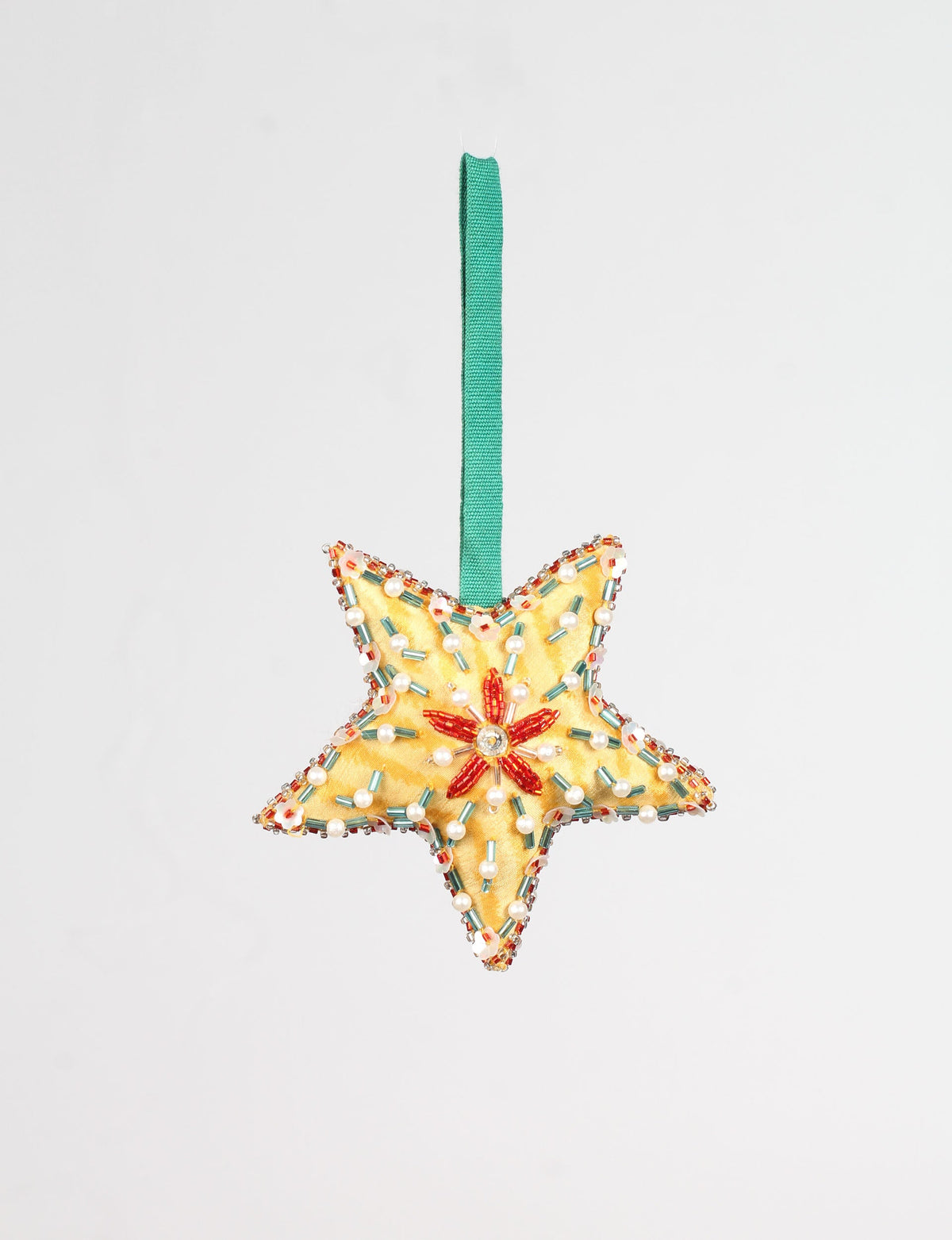 Yellow star-shaped ornament with red, white, and green bead embellishments and a green hanging loop, front view