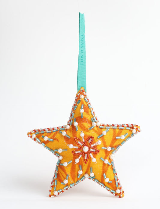 Christmas Star Ornaments made from upcycled saris with hand-embroidered Aari work, showcasing sustainable fashion and eco-friendly craftsmanship for ethical and green holiday decor.
