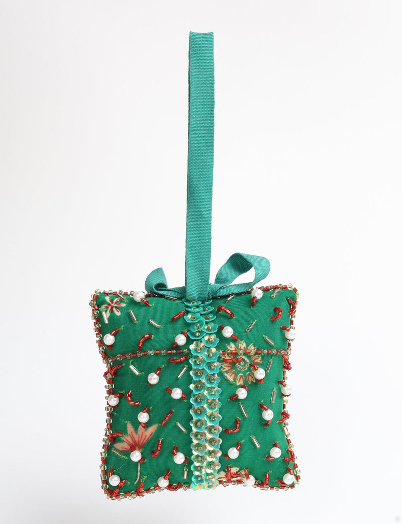 Green fabric gift-shaped ornament with red, white bead embellishments and a teal hanging loop and bow