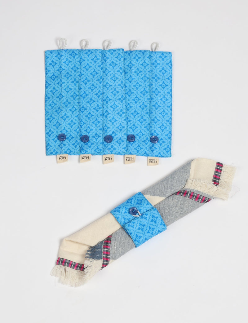 Set of 6 blue fabric napkin rings with floral pattern and button closure, shown flat and wrapped on a napkin