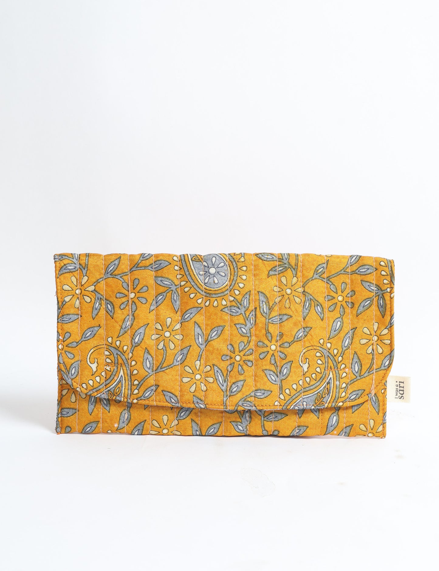 Quilted sunglasses case made from recycled sari products, featuring a secure magnetic closure. A chic example of ethical fashion, conscious clothing, and carbon neutral fashion. Protect your sunglasses while embracing circular fashion and upcycled garments.