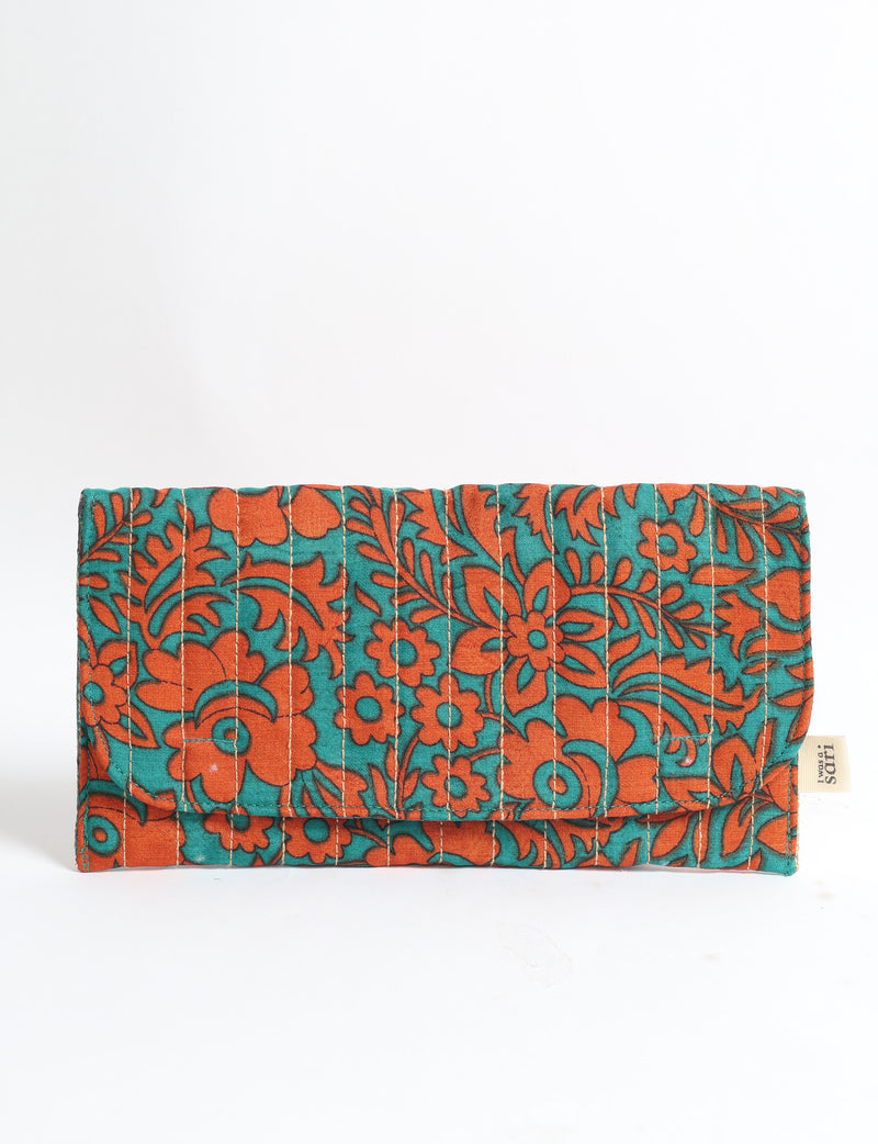 Quilted sunglasses case with orange floral and leaf pattern on teal fabric, front view, folded with visible stitching and label