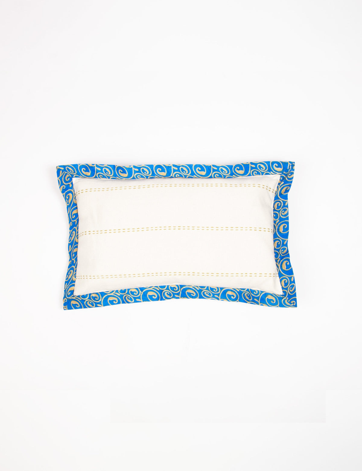 Rectangular lumbar cotton cushion cover with cream center and broad blue sari edging with gold swirl pattern, flat lay view