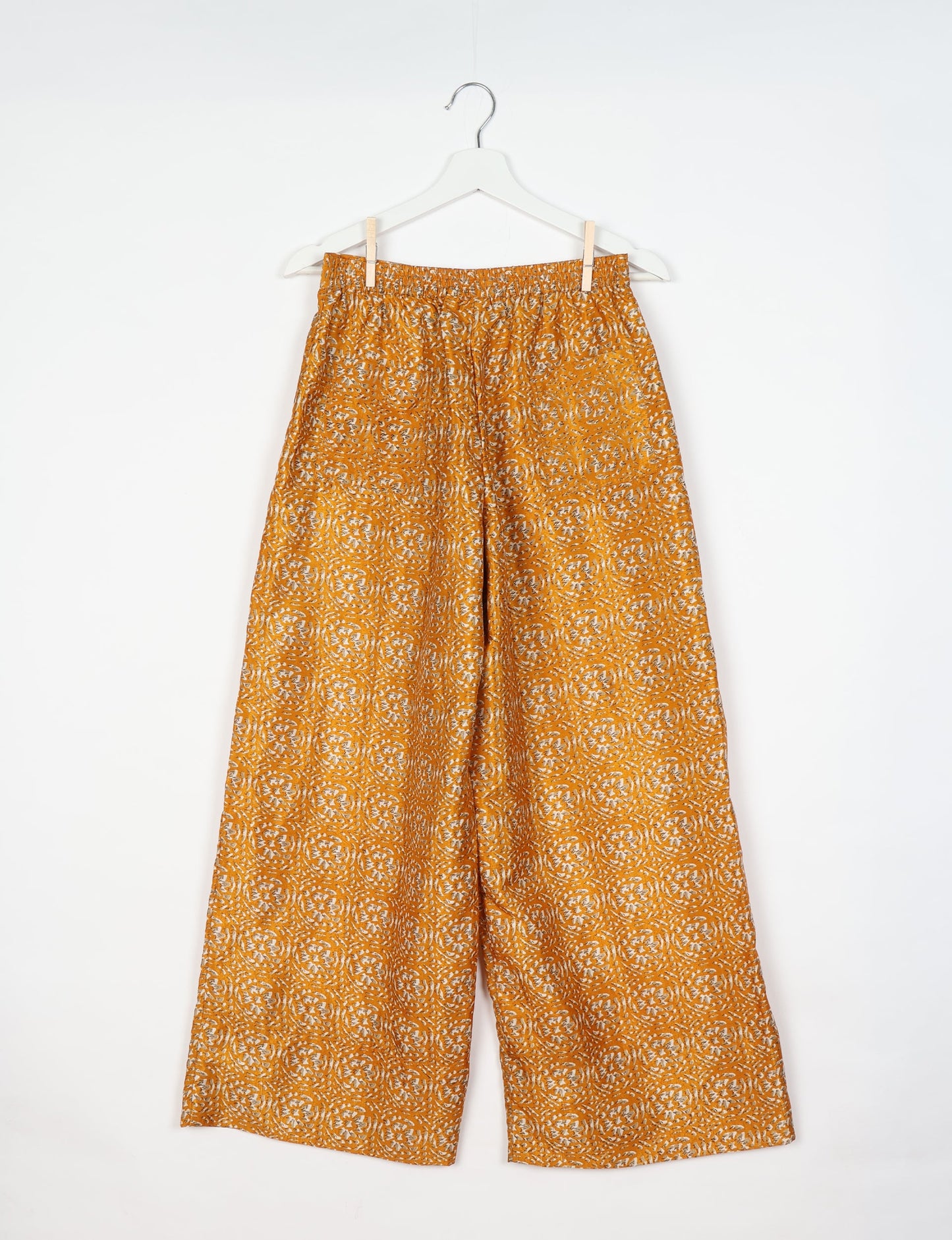 Upcycled women’s wide leg pants made from preloved saris, showcasing eco friendly clothes, zero waste clothing, and carbon neutral fashion.
