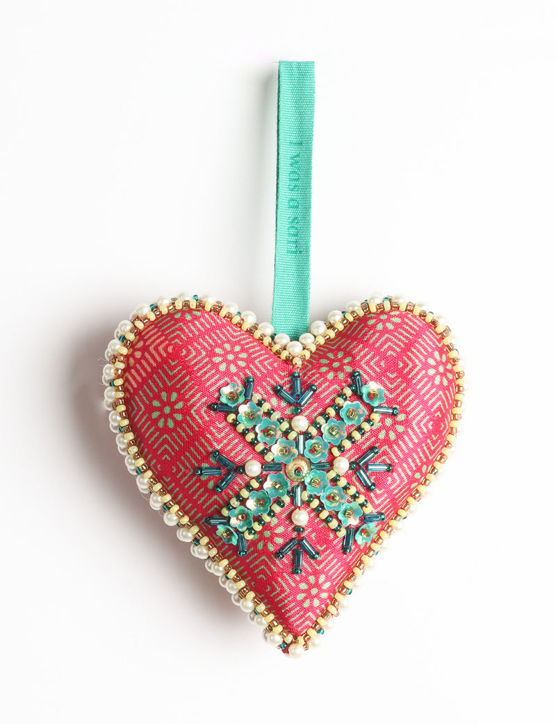 Red fabric heart ornament with yellow floral print, green and pearl bead embellishments, and green hanging loop