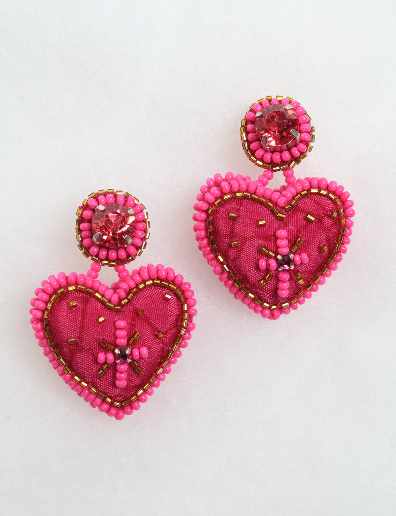 Pink heart drop earrings with fabric centers, surrounded by pink and gold beads, and red rhinestone studs on top