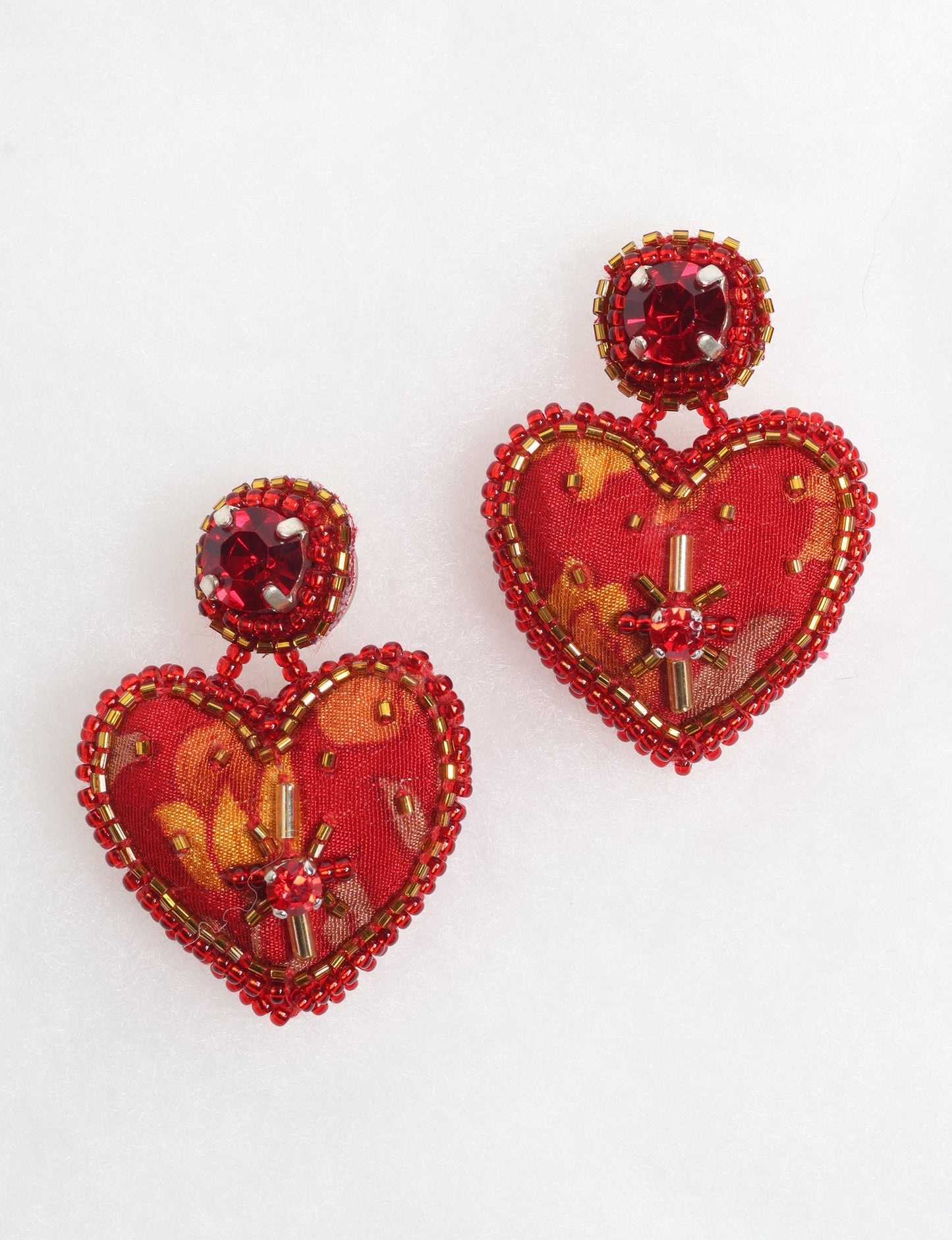 Hand-embroidered Heart Drop Earrings featuring intricate Aari stitching, crafted from recycled sari fabric. A stunning blend of upcycled clothing, ethical fashion, and circular fashion, these earrings embrace recycled sustainable fashion and earth-friendly clothing for a truly elegant, eco-conscious choice.