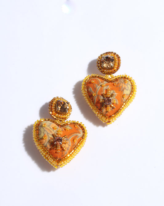 Hand-embroidered Heart Drop Earrings featuring intricate Aari stitching, crafted from recycled sari fabric. A stunning blend of upcycled clothing, ethical fashion, and circular fashion, these earrings embrace recycled sustainable fashion and earth-friendly clothing for a truly elegant, eco-conscious choice.