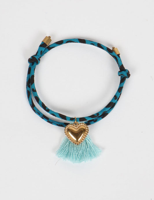Handmade rope bracelet from recycled sari fabric with gold heart charm and tassels—eco friendly cloth, climate neutral fashion, and upcycled women’s clothing.