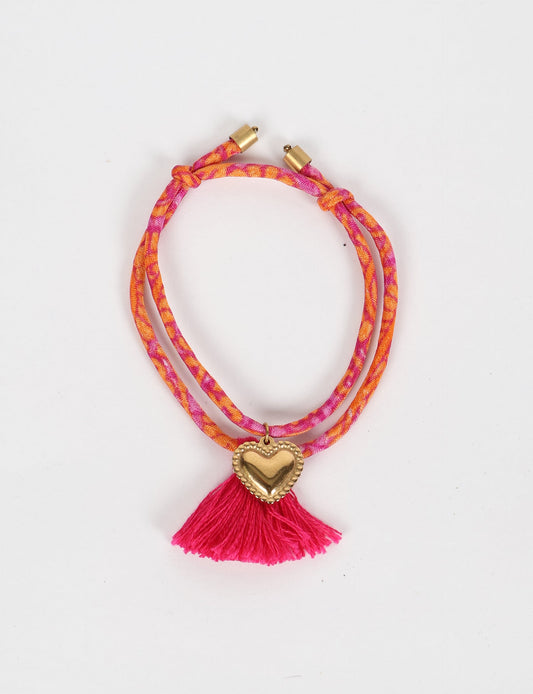 Handmade rope bracelet from recycled sari fabric with gold heart charm and tassels—eco friendly cloth, climate neutral fashion, and upcycled women’s clothing.