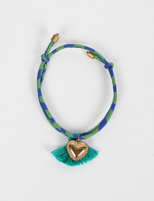 Handmade rope bracelet from recycled sari fabric with gold heart charm and tassels—eco friendly cloth, climate neutral fashion, and upcycled women’s clothing.