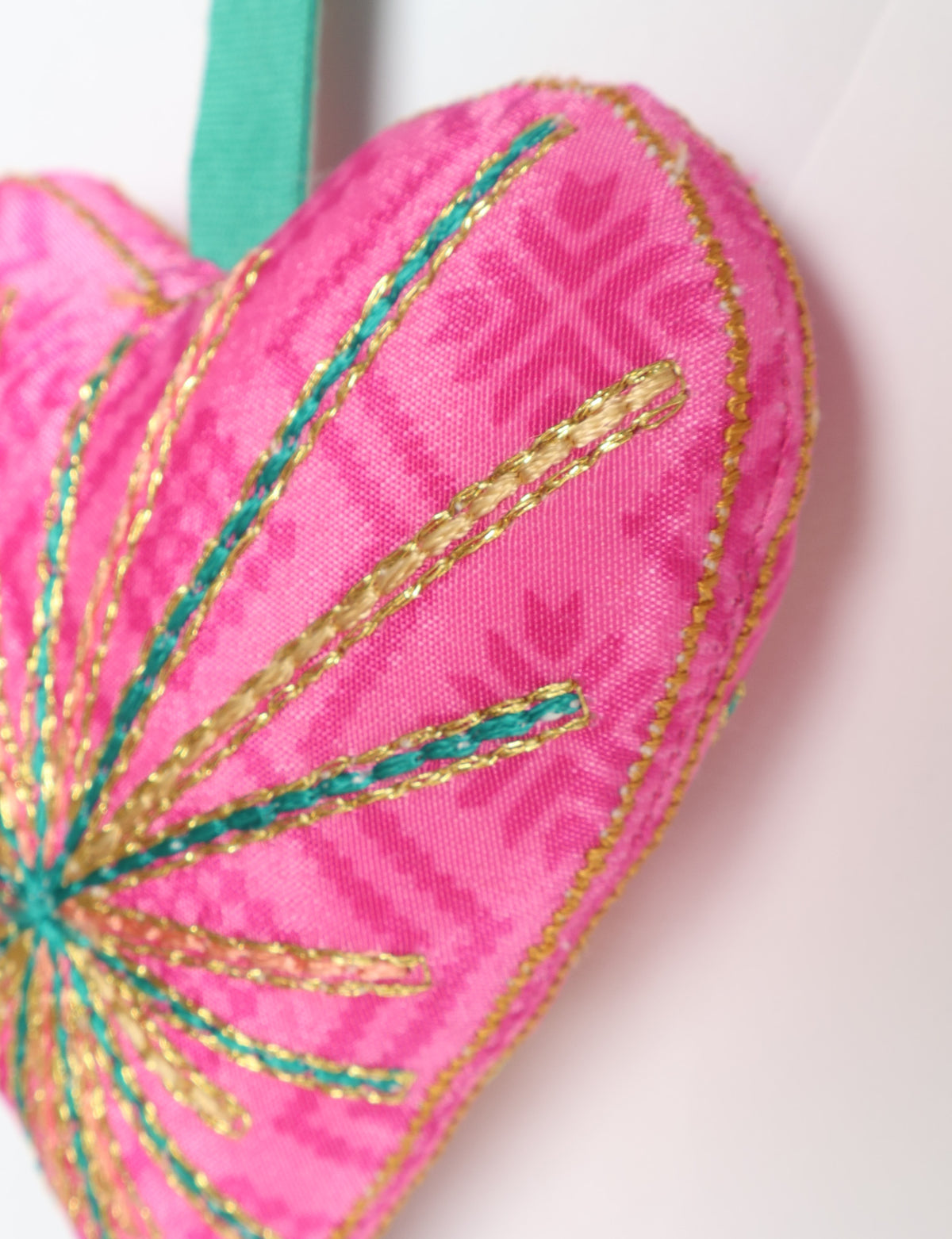 Timeless Heart ornament made from upcycled clothing and recycled fabric, filled with organic cotton and hand-finished with vibrant silk and metallic thread. An eco-friendly, carbon neutral fashion piece that supports green fashion and fair trade apparel.