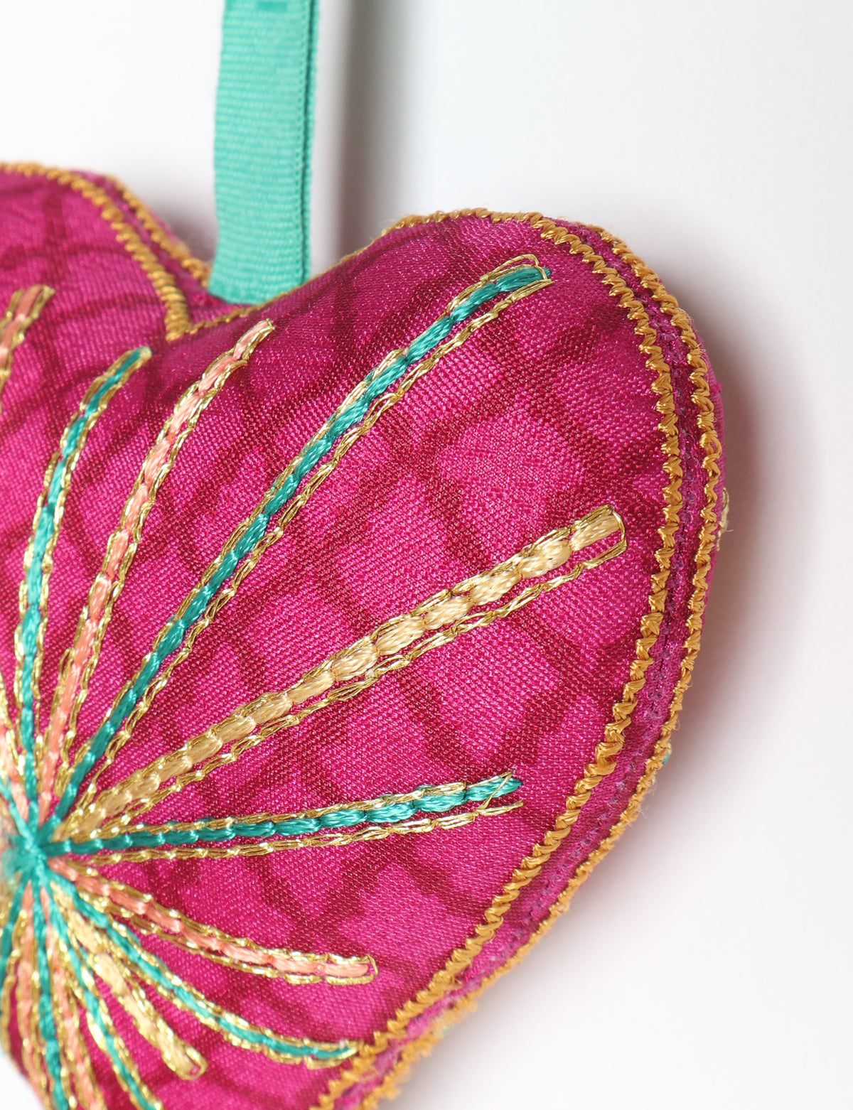 Timeless Heart ornament made from upcycled clothing and recycled fabric, filled with organic cotton and hand-finished with vibrant silk and metallic thread. An eco-friendly, carbon neutral fashion piece that supports green fashion and fair trade apparel.
