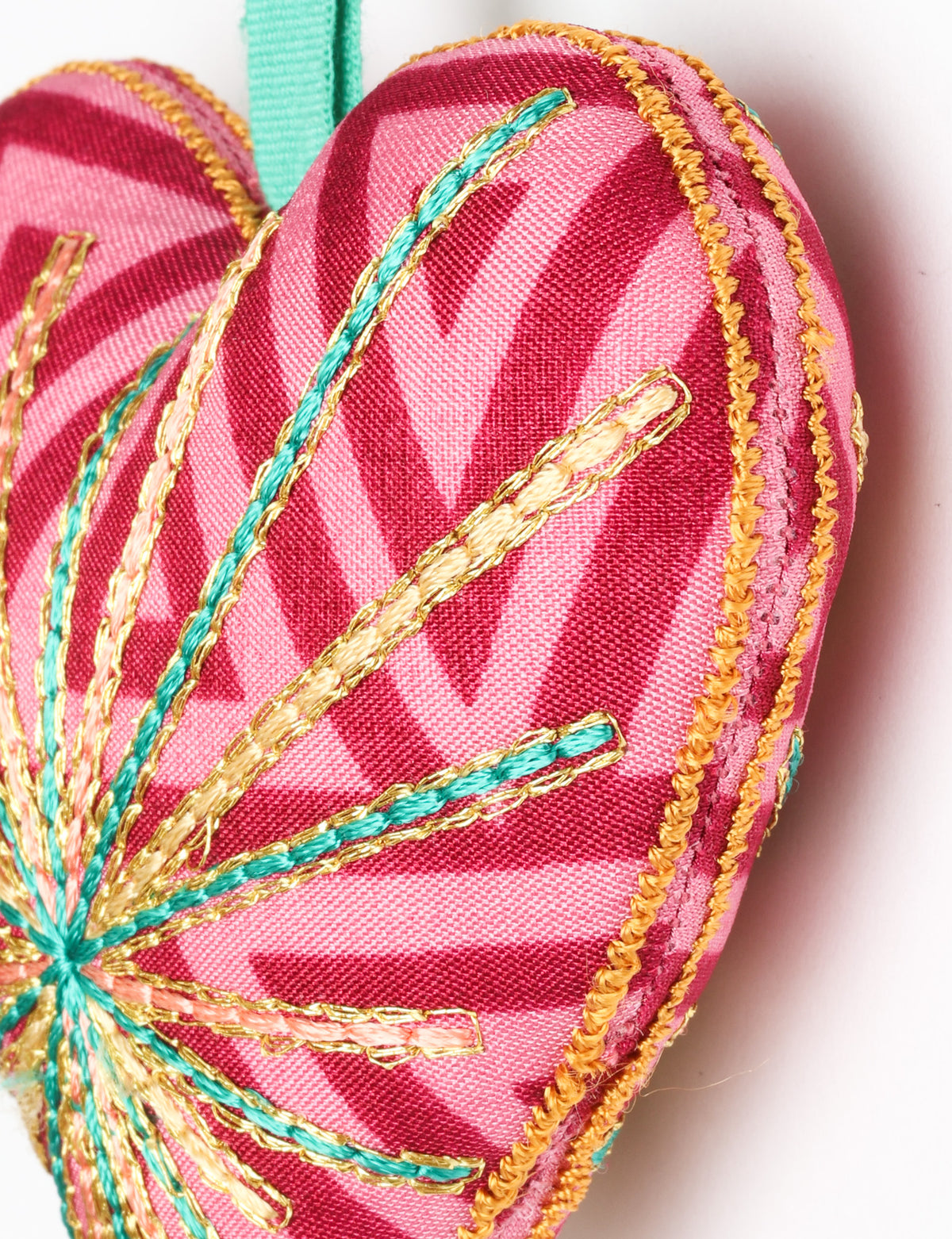 Timeless Heart ornament made from upcycled clothing and recycled fabric, filled with organic cotton and hand-finished with vibrant silk and metallic thread. An eco-friendly, carbon neutral fashion piece that supports green fashion and fair trade apparel.