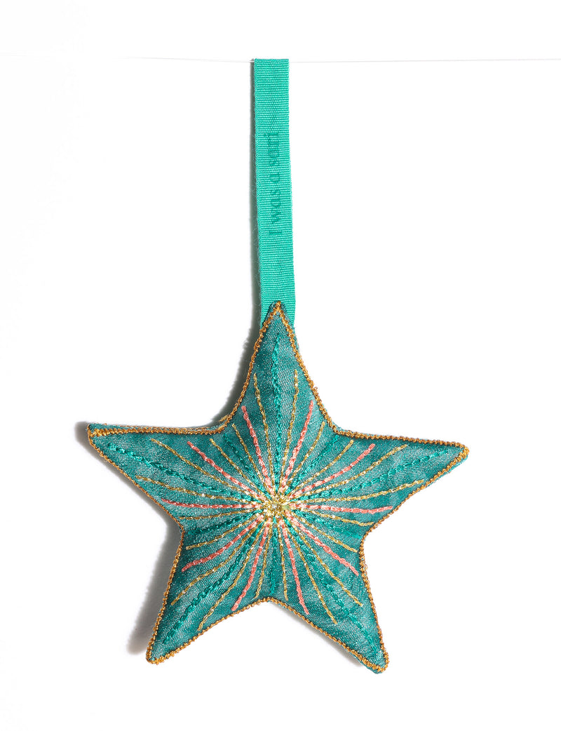 Timeless star ornament made from recycled sari fabric, featuring silk and metallic embroidery, crafted as part of green fashion, recycled clothing design, environmentally friendly clothing practices, and repurposed clothing traditions.