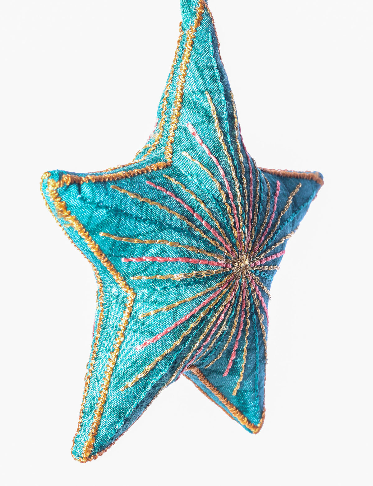 Timeless star ornament made from recycled sari fabric, featuring silk and metallic embroidery, crafted as part of green fashion, recycled clothing design, environmentally friendly clothing practices, and repurposed clothing traditions.
