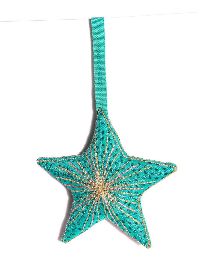 Timeless star ornament made from recycled sari fabric, featuring silk and metallic embroidery, crafted as part of green fashion, recycled clothing design, environmentally friendly clothing practices, and repurposed clothing traditions.