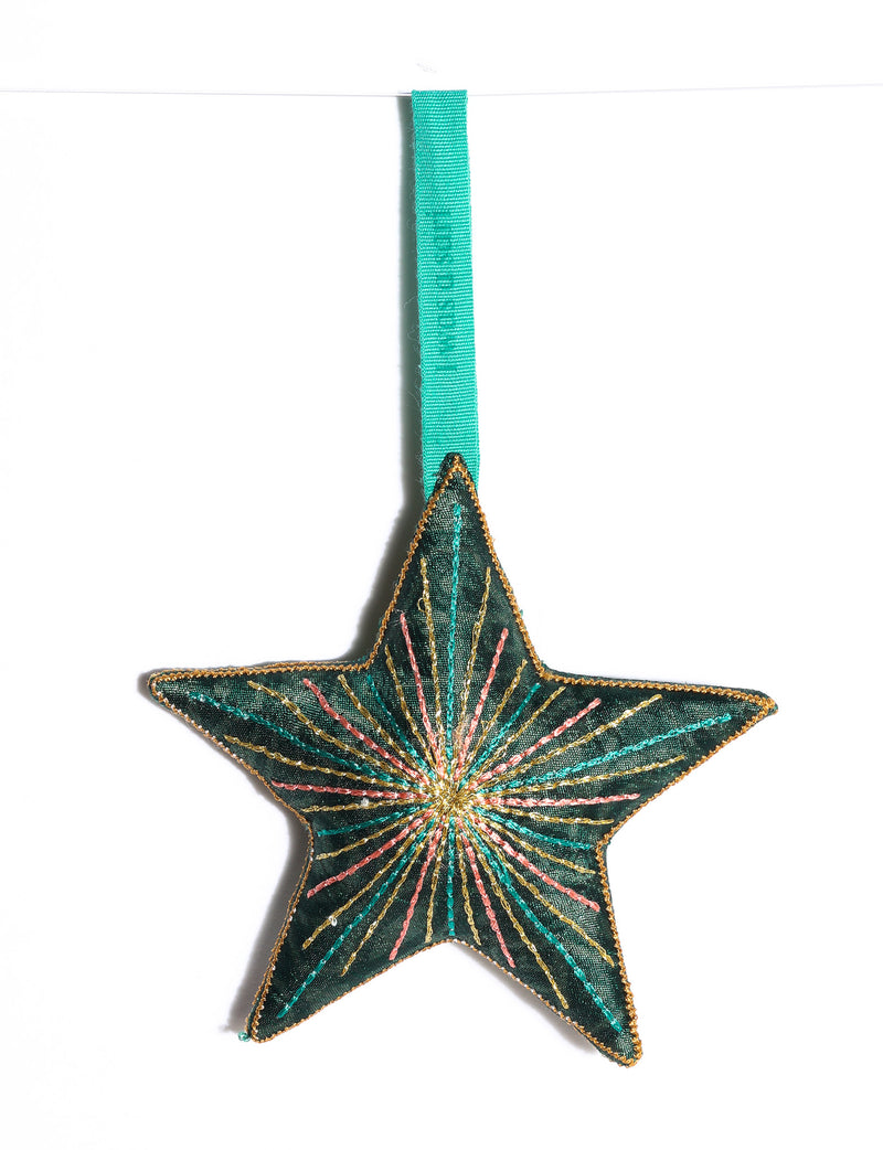 Timeless star ornament made from recycled sari fabric, featuring silk and metallic embroidery, crafted as part of green fashion, recycled clothing design, environmentally friendly clothing practices, and repurposed clothing traditions.
