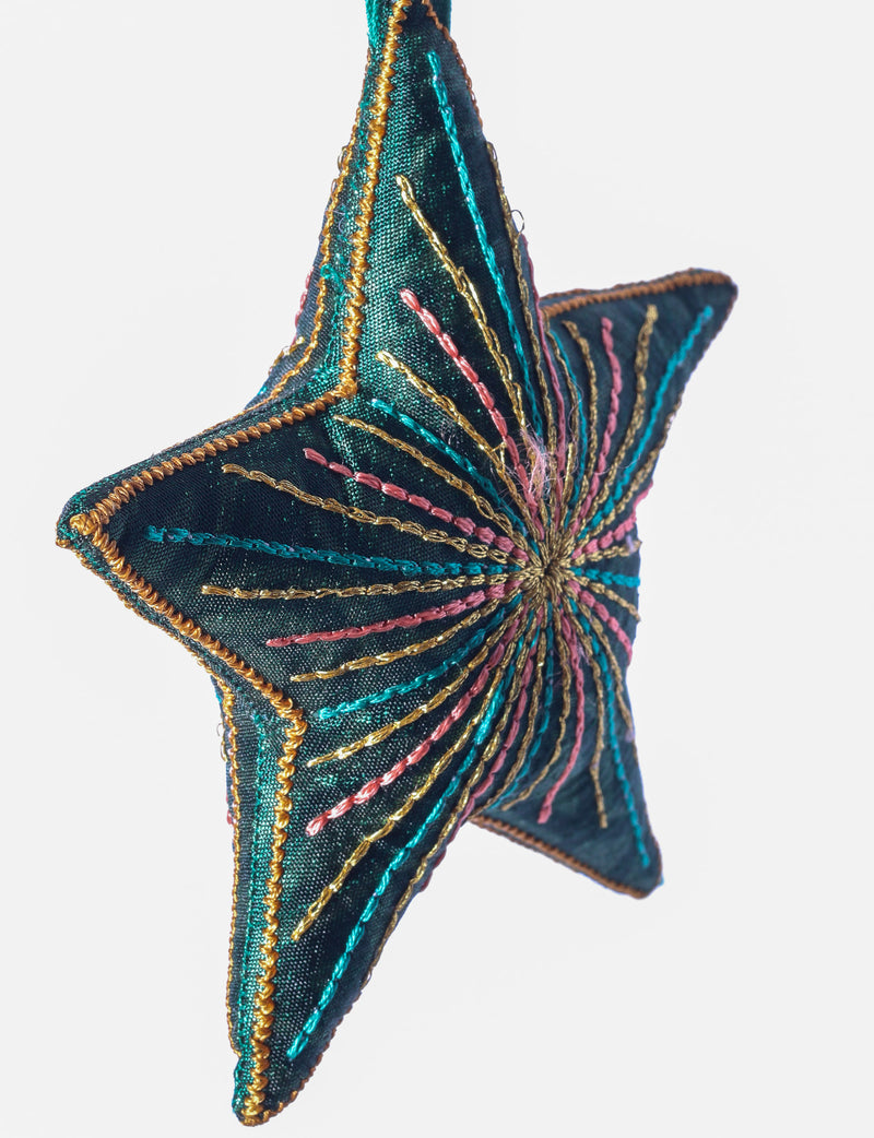 Timeless star ornament made from recycled sari fabric, featuring silk and metallic embroidery, crafted as part of green fashion, recycled clothing design, environmentally friendly clothing practices, and repurposed clothing traditions.