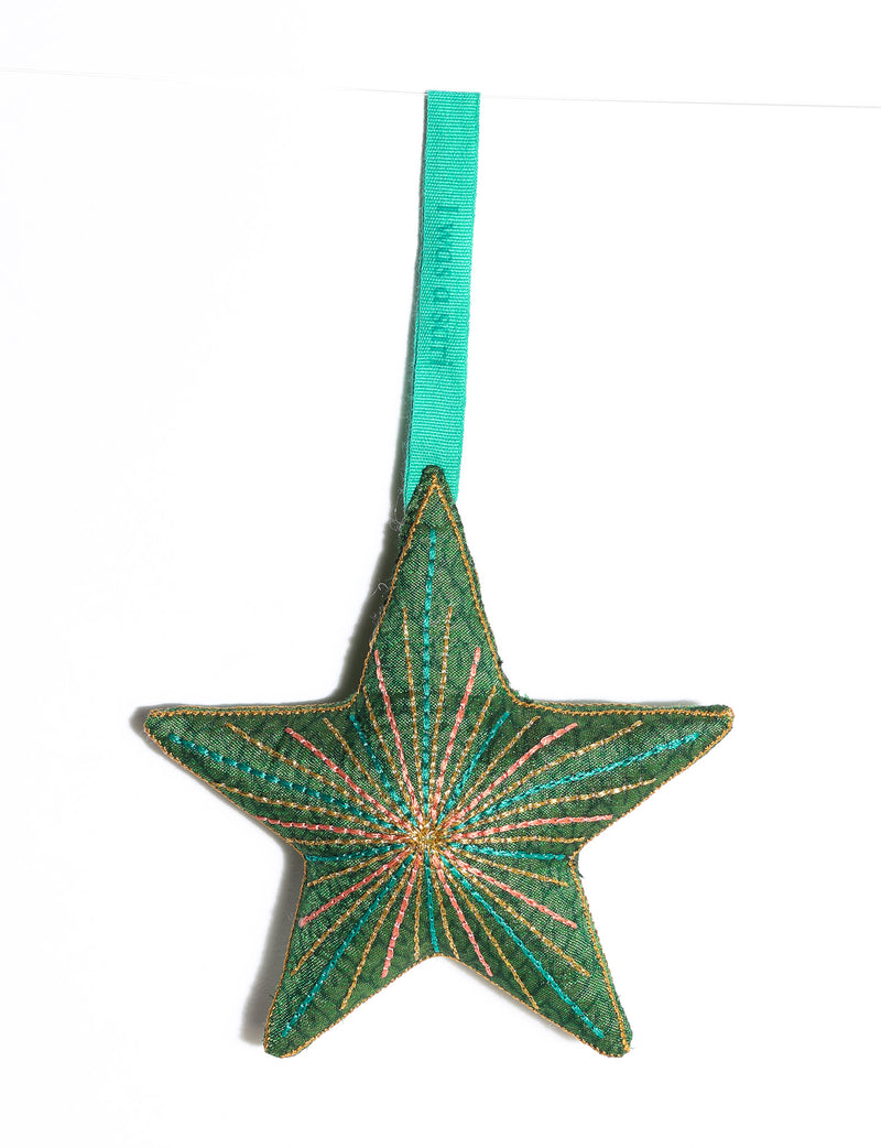 Timeless star ornament made from recycled sari fabric, featuring silk and metallic embroidery, crafted as part of green fashion, recycled clothing design, environmentally friendly clothing practices, and repurposed clothing traditions.