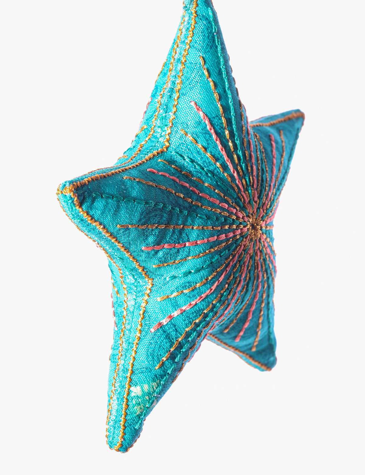 Timeless star ornament made from recycled sari fabric, featuring silk and metallic embroidery, crafted as part of green fashion, recycled clothing design, environmentally friendly clothing practices, and repurposed clothing traditions.
