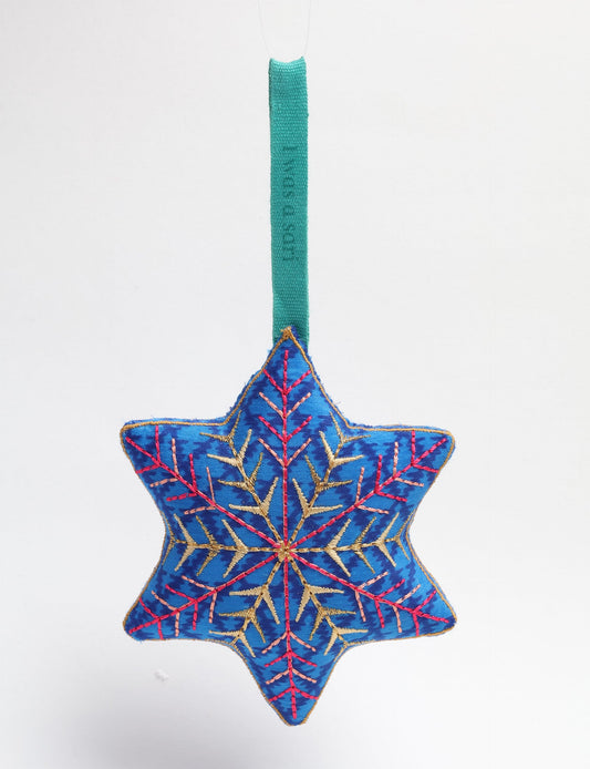 Timeless snowflake ornament made from preloved sari fabric with metallic embroidery, promoting green fashion, fair trade fashion, recycled material clothing, repurposed clothing, sustainable women's clothing, and circular fashion for a conscious lifestyle.