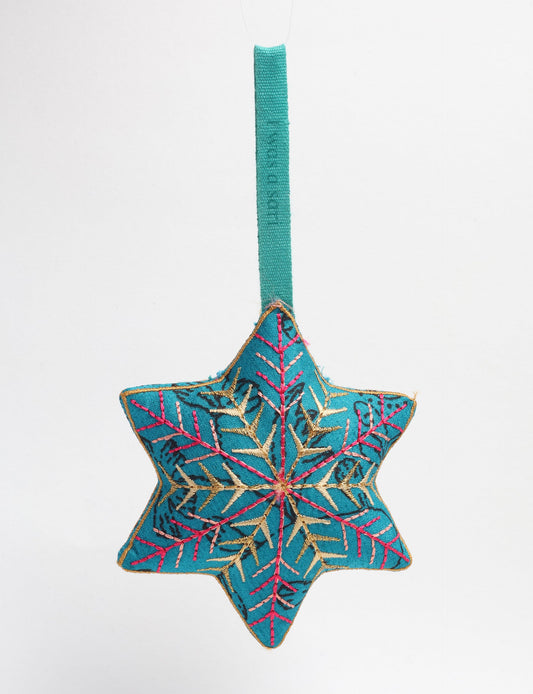Timeless snowflake ornament made from preloved sari fabric with metallic embroidery, promoting green fashion, fair trade fashion, recycled material clothing, repurposed clothing, sustainable women's clothing, and circular fashion for a conscious lifestyle.
