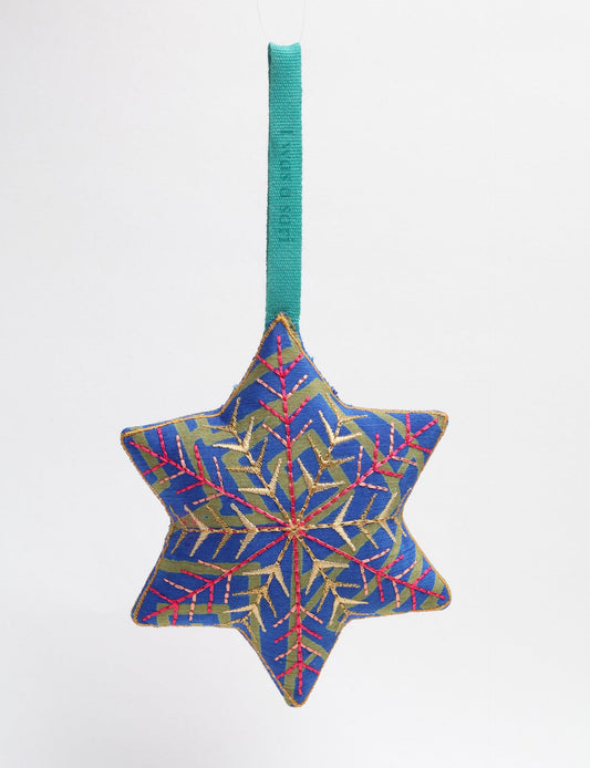 Timeless snowflake ornament made from preloved sari fabric with metallic embroidery, promoting green fashion, fair trade fashion, recycled material clothing, repurposed clothing, sustainable women's clothing, and circular fashion for a conscious lifestyle.