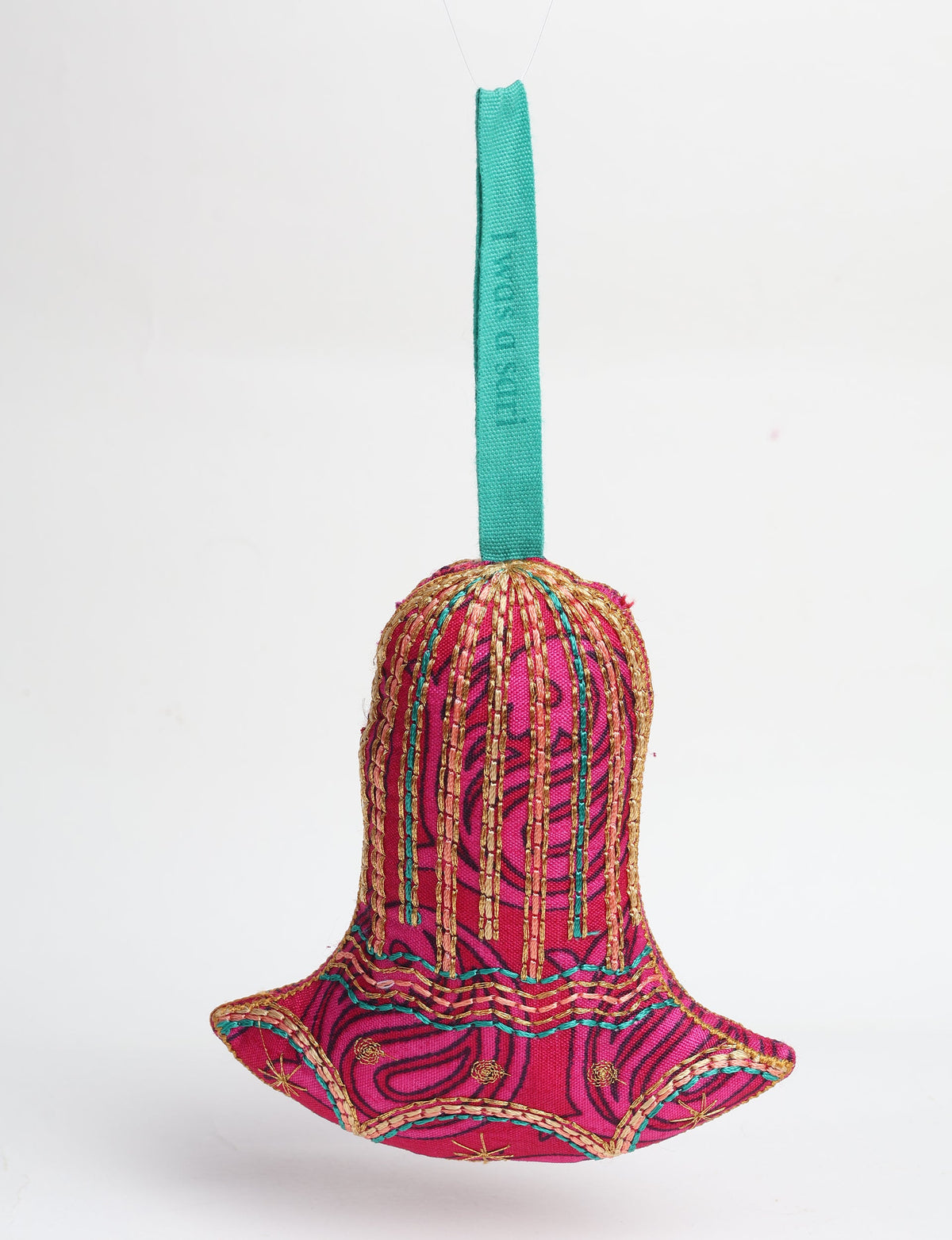 Red fabric bell ornament with gold and teal stitched details and a teal hanging loop with faint text visible