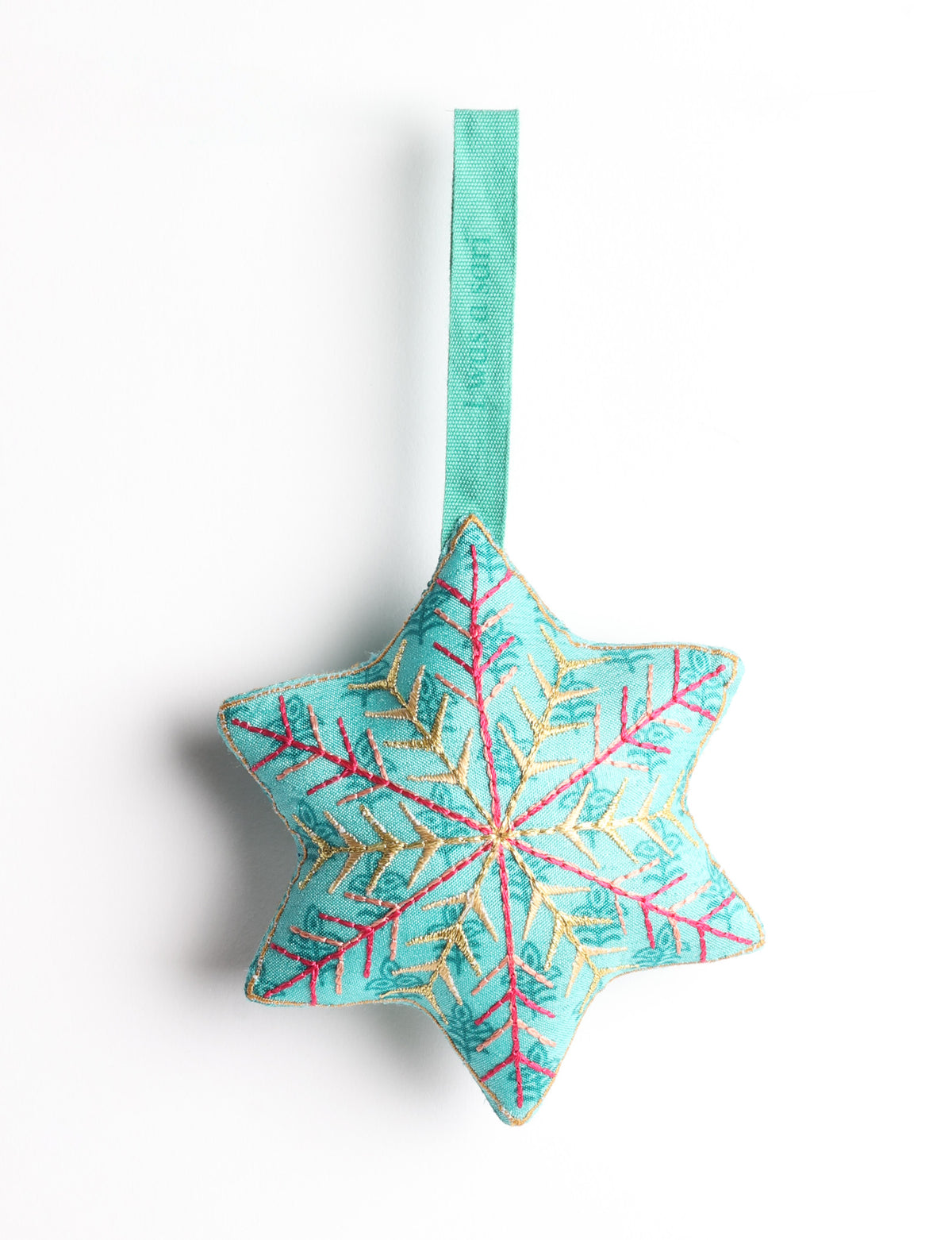 Blue fabric star-shaped ornament with gold and pink embroidered snowflake design and green hanging loop