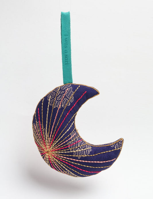 Timeless crescent moon ornament made from recycled materials and textile waste, featuring intricate embroidery. A zero waste and carbon offset accessory that supports circular fashion, fair trade fashion, and environmentally friendly clothing choices.
