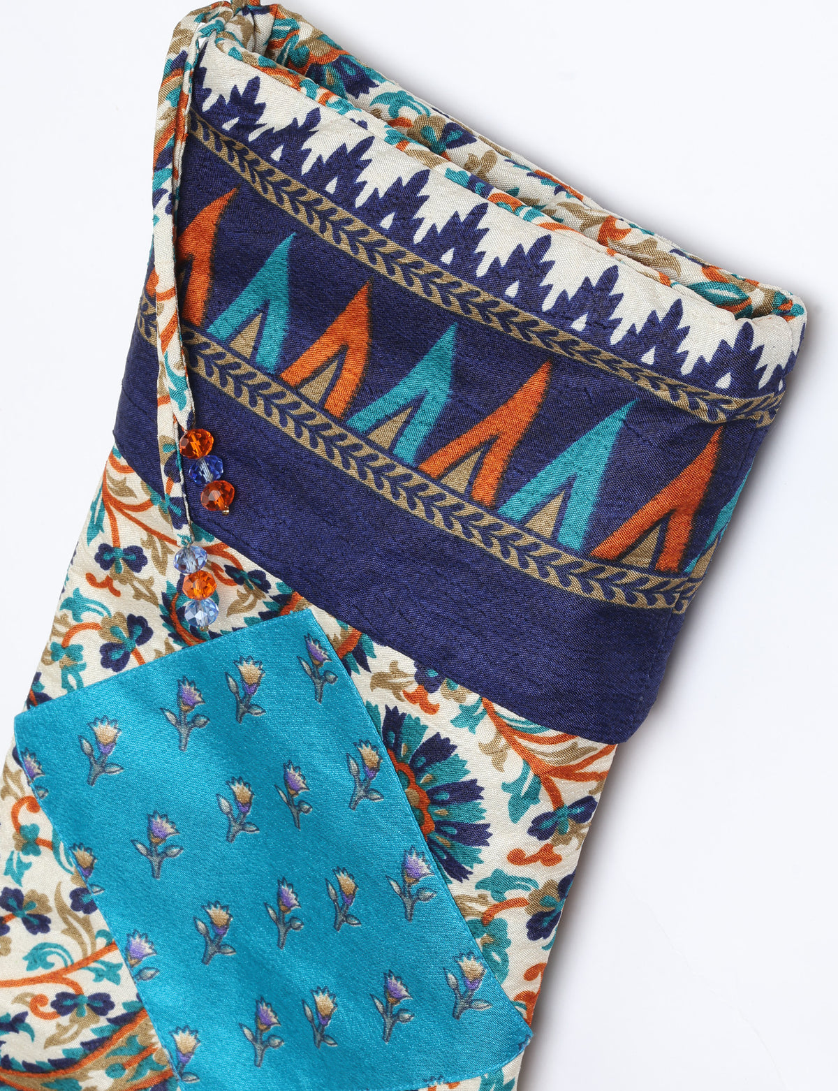 Timeless Christmas stocking made from recycled sari fabric, featuring colorful patchwork, tassel details, and crafted with care in line with circular fashion, upcycling fashion, carbon neutral clothing, and environmentally friendly clothing ideals — a beautiful piece of repurposed clothing and eco clothing for sustainable women’s fashion.