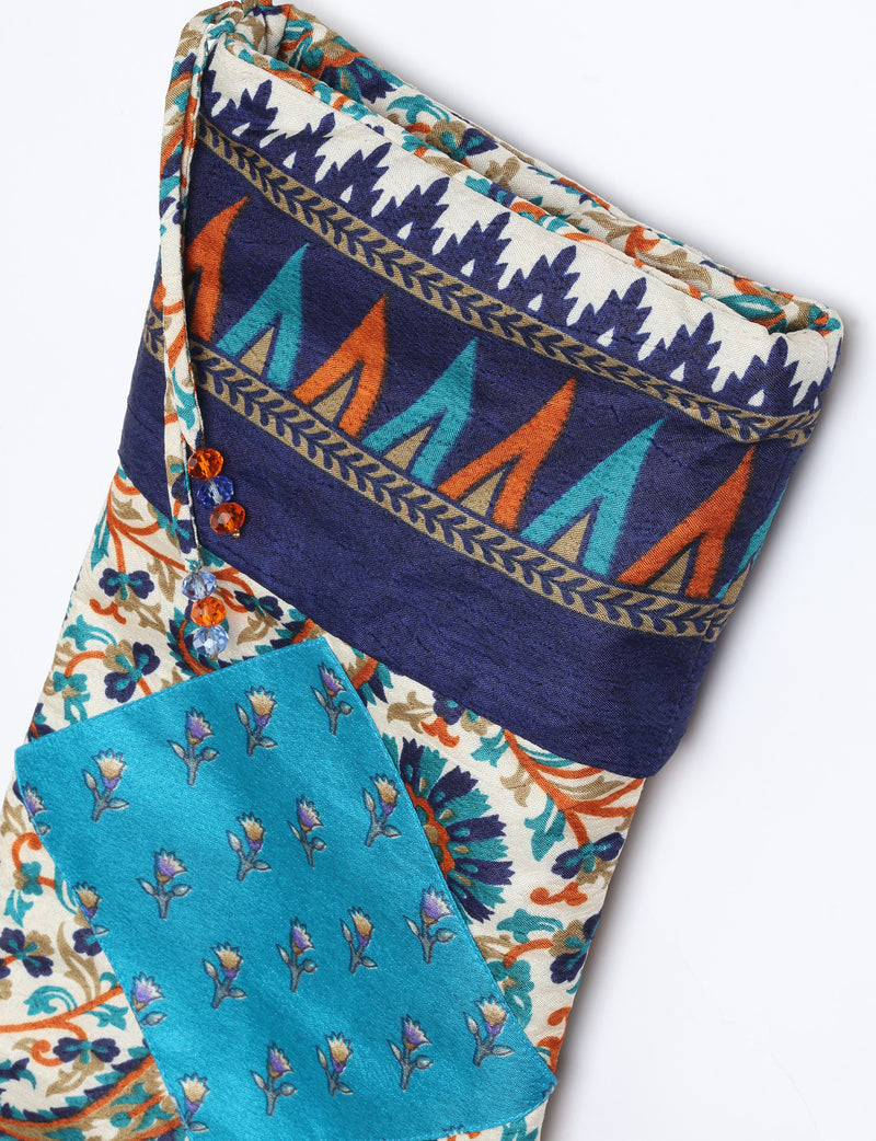 Timeless Christmas stocking made from recycled sari fabric, featuring colorful patchwork, tassel details, and crafted with care in line with circular fashion, upcycling fashion, carbon neutral clothing, and environmentally friendly clothing ideals — a beautiful piece of repurposed clothing and eco clothing for sustainable women’s fashion.