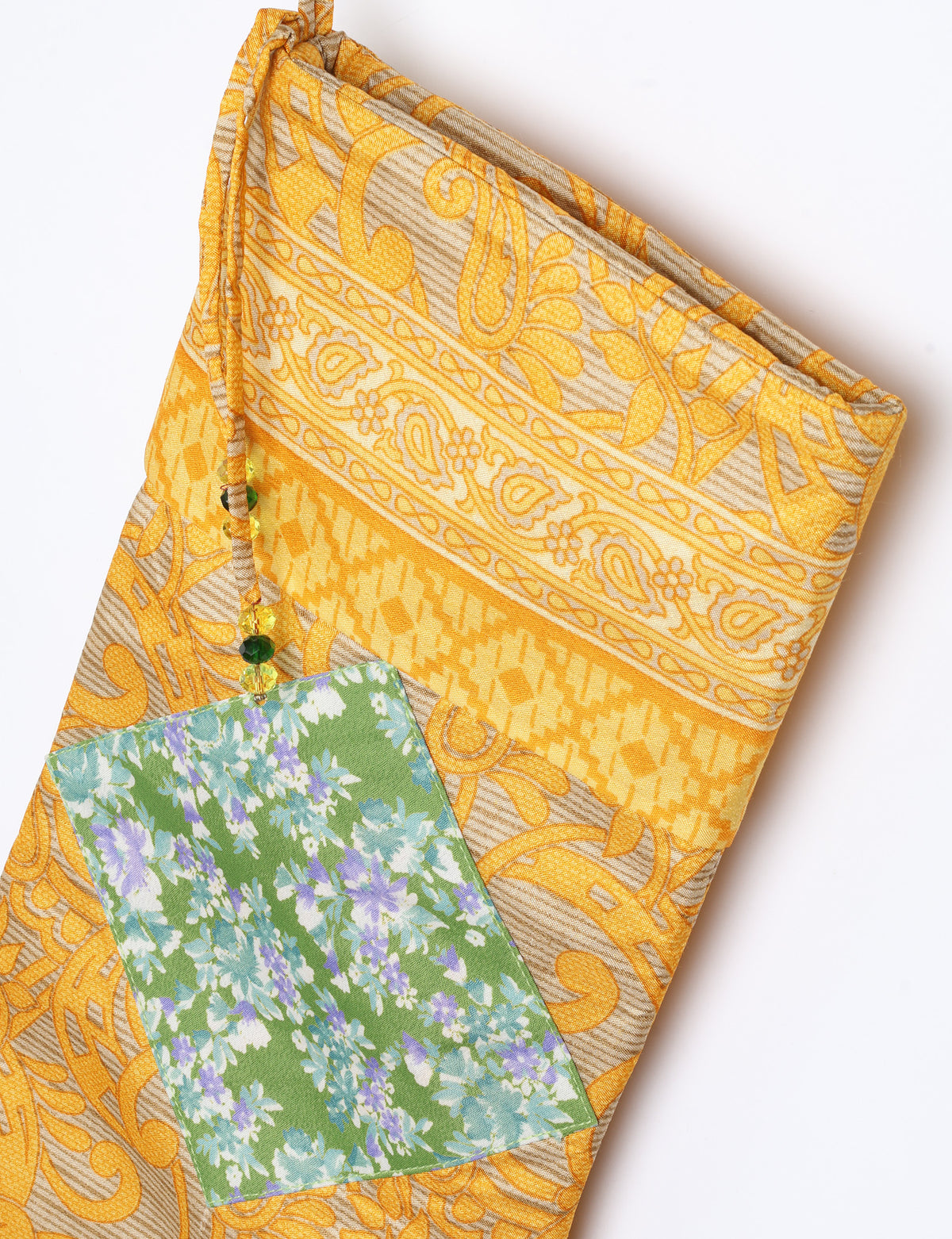 Timeless Christmas stocking made from recycled sari fabric, featuring colorful patchwork, tassel details, and crafted with care in line with circular fashion, upcycling fashion, carbon neutral clothing, and environmentally friendly clothing ideals — a beautiful piece of repurposed clothing and eco clothing for sustainable women’s fashion.