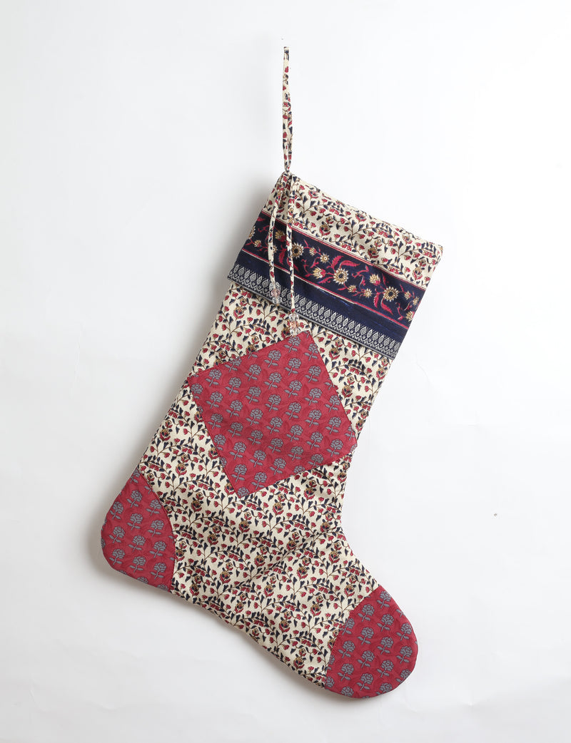 Timeless Christmas stocking made from recycled sari fabric, featuring colorful patchwork, tassel details, and crafted with care in line with circular fashion, upcycling fashion, carbon neutral clothing, and environmentally friendly clothing ideals — a beautiful piece of repurposed clothing and eco clothing for sustainable women’s fashion.