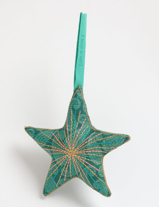 Timeless star ornament made from recycled sari fabric, featuring silk and metallic embroidery, crafted as part of green fashion, recycled clothing design, environmentally friendly clothing practices, and repurposed clothing traditions.