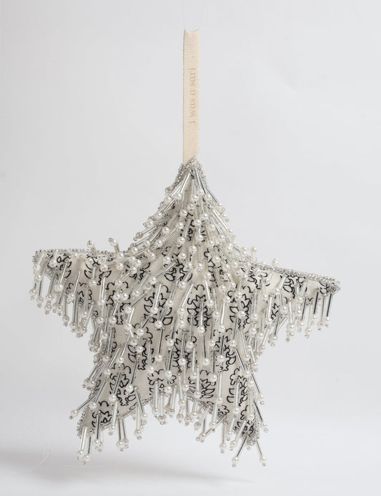 Upcycled silver star Christmas ornament made from recycled sari fabric, hand embroidered with sequins, pearls, and glass beads — a fair trade, slow fashion, and zero waste clothing accessory.